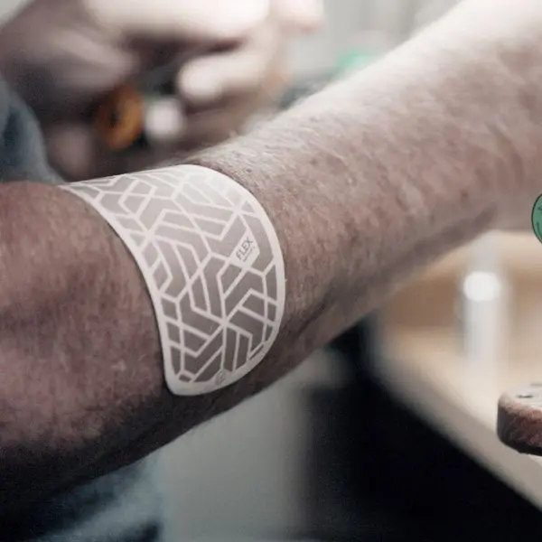 The white Kailo Flex patch worn on a forearm