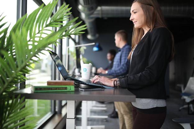 Woman standing at an ergonomically correct desk